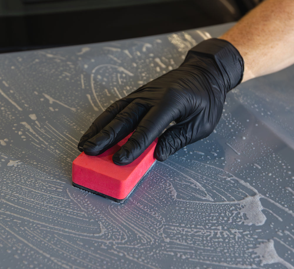 Red Clay Sponge with a polymer face being used by hand on wet paintwork